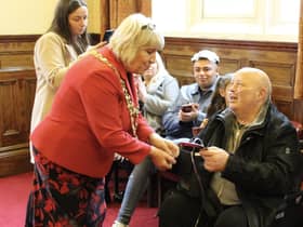 Dave Grundy receives the Heart of the Community award from Mayor of Wigan Coun Marie Morgan