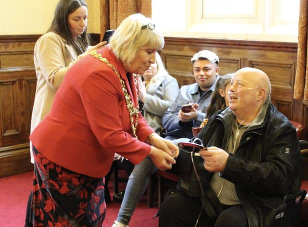 Dave Grundy receives the Heart of the Community award from Mayor of Wigan Coun Marie Morgan