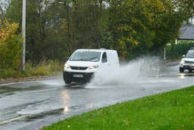 Vehicles drive through flooding on Wigan Lower Road in November 2021