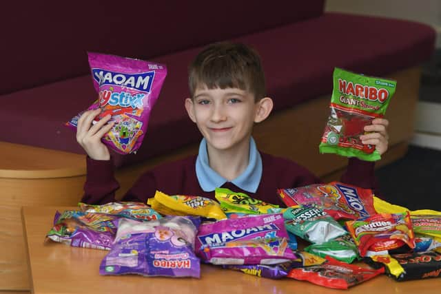Callum Holden, 10, with sweets for people from Ukraine