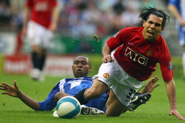 Manchester United's Argentinian forward Carlos Tvez (R) is tackled by Wigan Athletic's English defender Fitz Hall during their English Premier League football match at The JJB Stadium in Wigan, northwest England, on May 11, 2008. AFP PHOTO/PAUL ELLIS