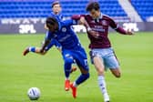 Akeel Higgins shields the ball against Aston Villa