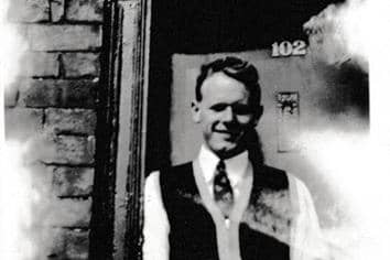 Ted in front of the ill-fitting and unpainted front door of the family home in Miry Lane
