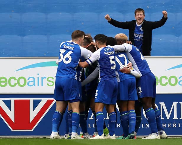 Josh Windass is mobbed after scoring the winner for Latics against West Brom in October 2018