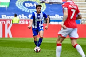 James Carragher looks to pick a pass against Wrexham