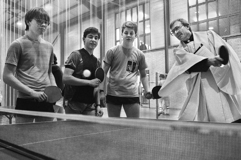 A service of a different kind from the Auxilliary Bishop of Liverpool, John Rawsthorne, who showed his table tennis skills after blessing the new sports hall and other buildings at St. John Rigby College, Orrell, on Wednesday 16th of April 1986.