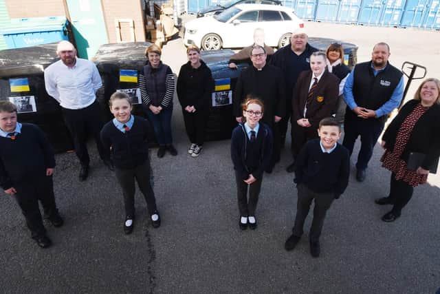 Pupils from the School Council at Orrell St James' RC primary school join staff at BA Berry Builders at Hewitt Business Park, Orrell, to help pack and load the food and items donated to send to Ukraine.