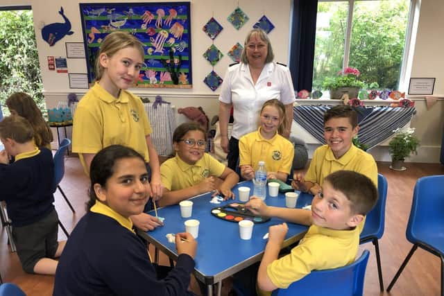 Church leader Elaine Rogers with pupils from Nicol Mere Primary School