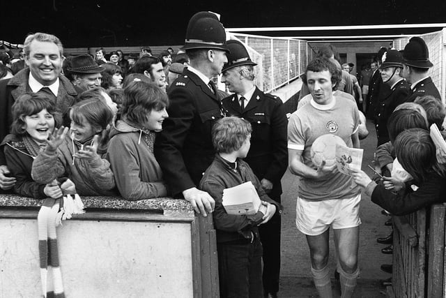 Manchester City captain Mike Summerbee leads his team out for an end of season friendly against the Northern Premier League at Springfield Park on Tuesday 7th of May 1974. The match was a 2-2 draw.