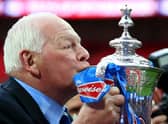 Wigan chairman Dave Whelan kisses the trophy following his team's 1-0 victory during the FA Cup with Budweiser Final between Manchester City and Wigan Athletic at Wembley Stadium on May 11, 2013 in London, England.  (Photo by Alex Livesey/Getty Images)