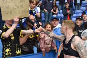 James McClean gives his shirt to a lucky fan at Reading after Latics' relegation was confirmed