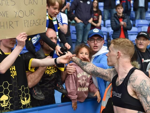 James McClean gives his shirt to a lucky fan at Reading after Latics' relegation was confirmed