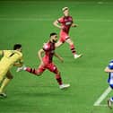 Dale Taylor slides home the opening goal against Huddersfield