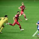 Dale Taylor slides home the opening goal against Huddersfield