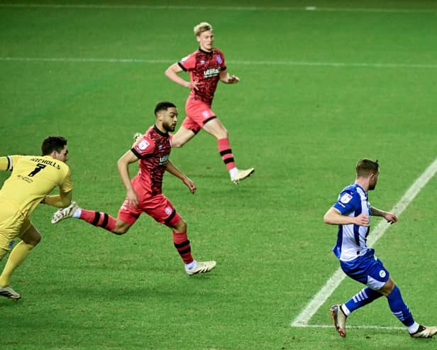 Dale Taylor slides home the opening goal against Huddersfield