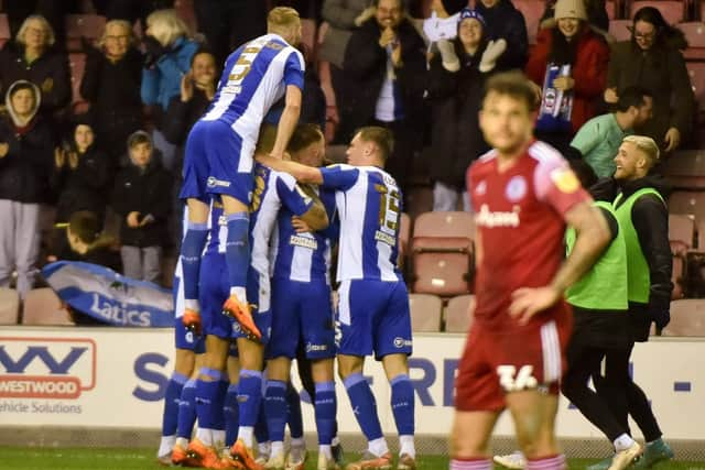 The Latics players celebrate another goal against Accrington