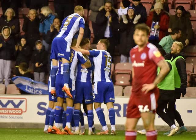 The Latics players celebrate another goal against Accrington