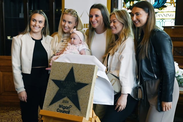 Football champion Ella Toone, Lioness and European Championship Winner, pictured with family and friends at a ceremony to present her Wigan Council star.