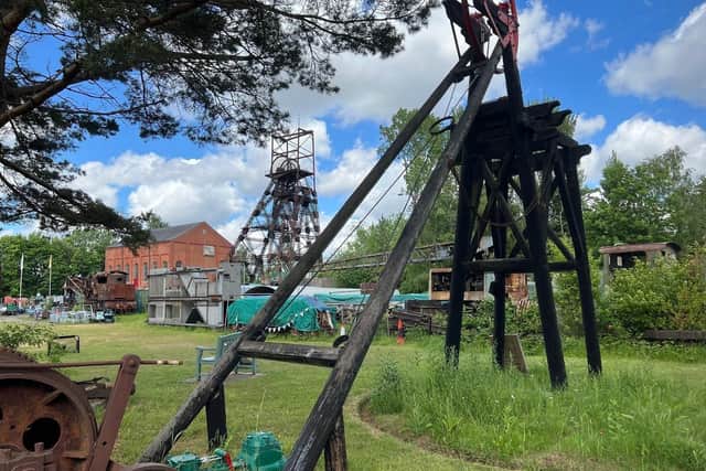 Headgear which once stood in Fred Dibnah's garden is in the foreground, with the museum's larger headgear in the background