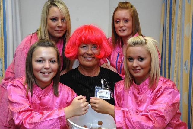 RETRO 2007 Health and Beauty Therapy students and staff at Wigan and Leigh College, Parsons Walk, Wigan wore pink and collected money from fellow students in aid of Breast Cancer.   Pictured with lecturer Norma Meadows (seated) with, from left,  Kirstie Swift, Siobhan Ready, Coran Thomas and Laura Keggin.