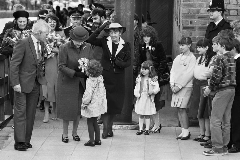 A big moment for a little girl.....she dashed out of the crowd on the Heritage Centre forecourt to present a posy to the Queen, during her visit to Wigan in 1986.