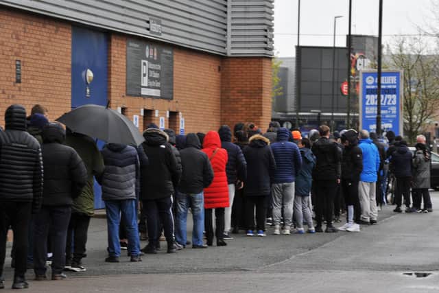 Latics fans queue round the DW Stadium in search of a ticket for Shrewsbury