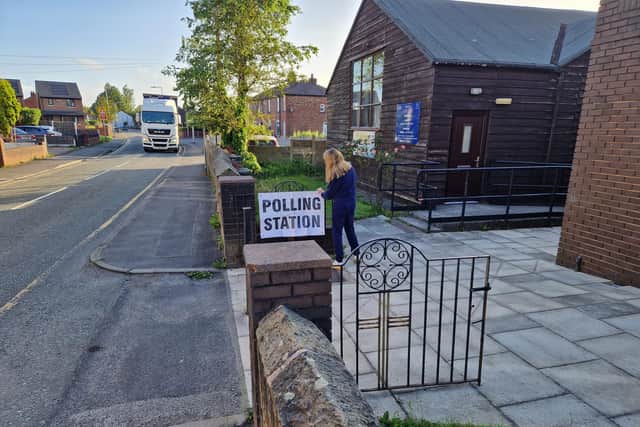 The polling station sign being put up at St Francis's Church, Kitt Green, before the general election polls opened this morning (July 4)