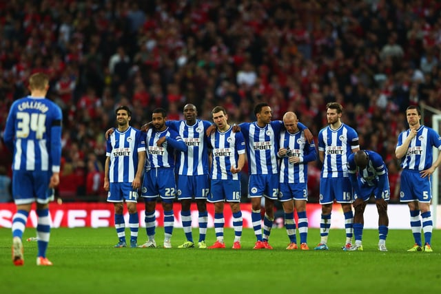 Jordi Gomez of Wigan Athletic (L) and team mates look on during the penalty shoot out during the FA Cup Semi-Final match between Wigan Athletic and Arsenal at Wembley Stadium on April 12, 2014 in London, England.