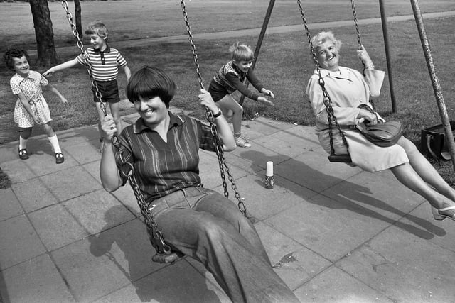Barbara Marsden and Jane Warburton given a push by Joanne and Stephen Marsden and Stuart Taylor on the swings at Alexandra Park in August 1978