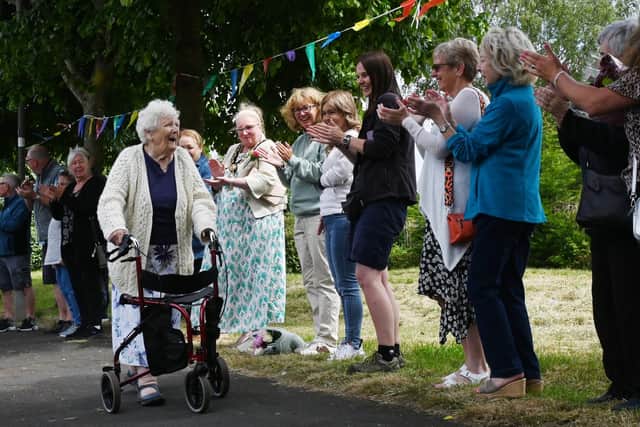 Friends, family, members of Ashton Deaf Club, neighbours and Mayor of St Helens Coun Lynn Clarke lined the streets to celebrate the end of Cath Brookfield's fund-raising challenge