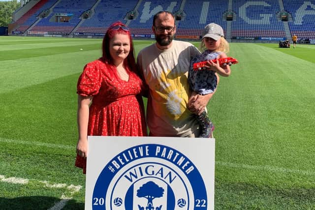 Kayley and Scott Parkinson at the DW Stadium with two-year-old daughter Elvie