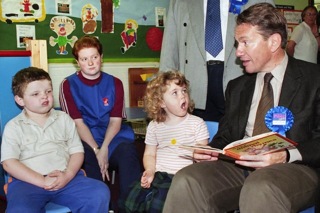 Former Tory Defence Minister, Michael Portillo, reading for young Wiganers at the Linacre creche during a visit to Wigan College as part of his backing for Conservative candidate, Tom Peet, in the upcoming local by election in September 1999.