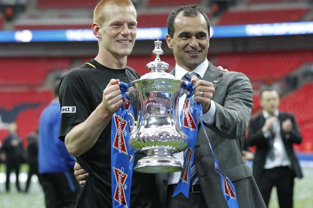 Wigan Athletic's Spanish manager Roberto Martinez (R) poses with goal scorer Wigan Athletic's English midfielder Ben Watson (L) and the FA Cup after after winning the English FA Cup final football match between Manchester City and Wigan Athletic at Wembley Stadium in London on May 11, 2013.  Substitute Ben Watson scored an injury-time winner to give Wigan Athletic a sensational 1-0 win over Manchester City at Wembley Stadium on Saturday in the biggest FA Cup final upset in 25 years.