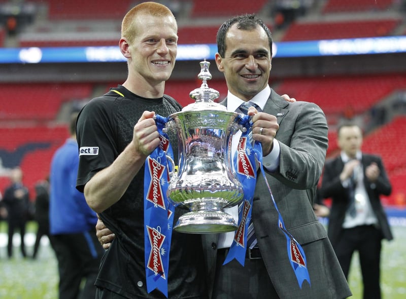 Wigan Athletic's Spanish manager Roberto Martinez (R) poses with goal scorer Wigan Athletic's English midfielder Ben Watson (L) and the FA Cup after after winning the English FA Cup final football match between Manchester City and Wigan Athletic at Wembley Stadium in London on May 11, 2013.  Substitute Ben Watson scored an injury-time winner to give Wigan Athletic a sensational 1-0 win over Manchester City at Wembley Stadium on Saturday in the biggest FA Cup final upset in 25 years.