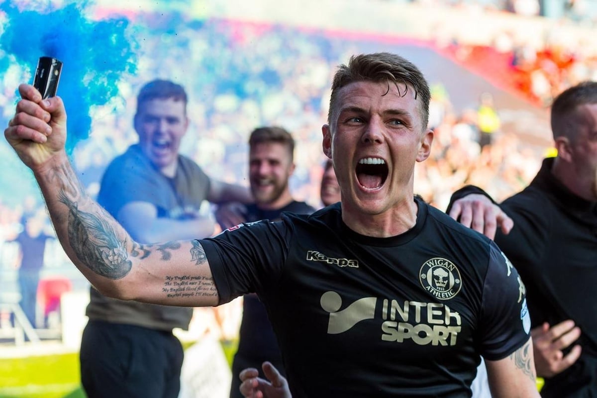 Former Wigan Athletic title winner joins League One rivals on two-year deal