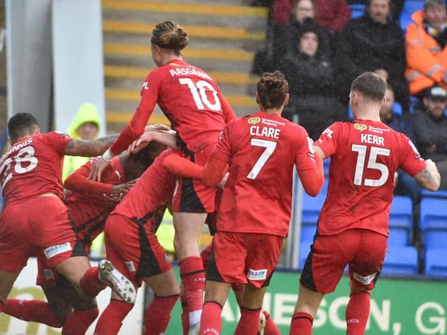 Matt Smith is mobbed after putting Latics in front