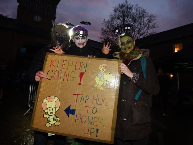 Ben Hopkins, Jack Hopkins, seven, and Carrie Schofield show support for the runners