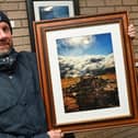 Photographer Chris Scaldwell with his work.
