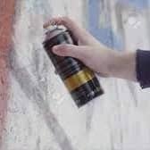 Stock image of hand holding spray can