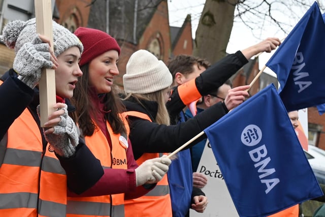 Striking workers waved flags as they called for improved pay