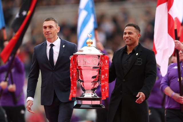 Kevin Sinfield and Jason Robinson carry the men's trophy ahead of the game (Photo by Charlotte Tattersall/Getty Images for RLWC)