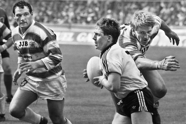 Wigan captain Graeme West grasps thin air as Widnes's scrum-half, Wigan born Andy Gregory, makes a break with Brian Case moving in during the Challenge Cup Final at Wembley on Saturday 5th of May 1984.
Wigan lost the match 6-19.