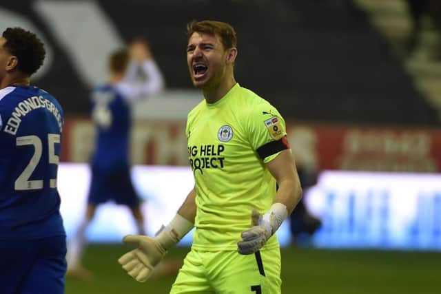 Jamie Jones celebrates a big win for Latics against Blackpool - as the players wait to discover who the new manager will be