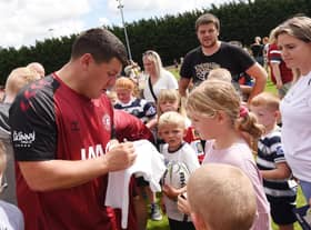 Matty Peet takes the time to sign some autographs at Wigan Warriors' open training session