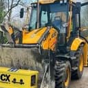 Kenneth Smith's coffin was transported in the front bucked of a JCB vehicle