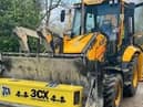 Kenneth Smith's coffin was transported in the front bucked of a JCB vehicle