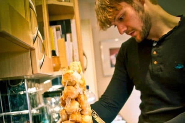 Wigan Bake-Off winner John Whaite puts the finishing touches to a croque en bouche