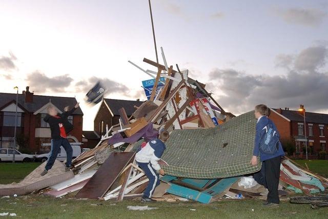 Youngsters help to build a bonfire on Whitledge Green, Bryn, in 2006
