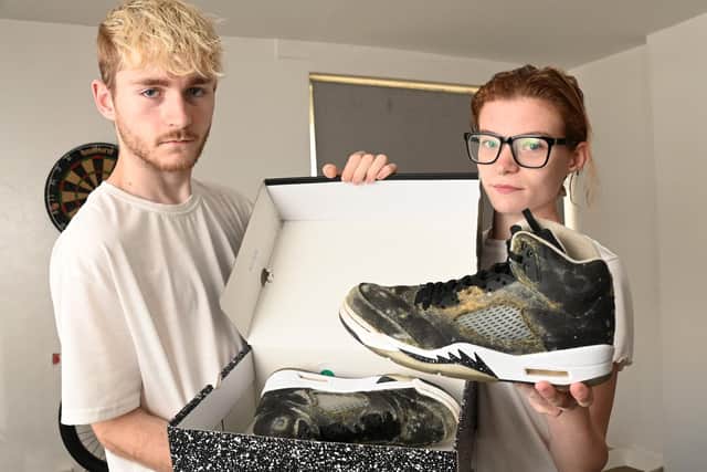 Jasmin Lyon and partner Aiden Gerrard have been living in a damp flat in Scholes, Wigan, for a year.  Their property is mouldy and their health is suffering.  Pictured with a new part of trainers which went mouldy in the shoebox because of the conditions in the accommodation.