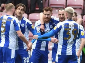 The Latics players celebrate Will Keane's goal against Wimbledon